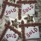 SOLD sign earring