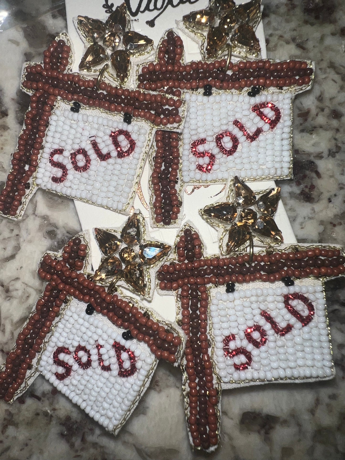 SOLD sign earring